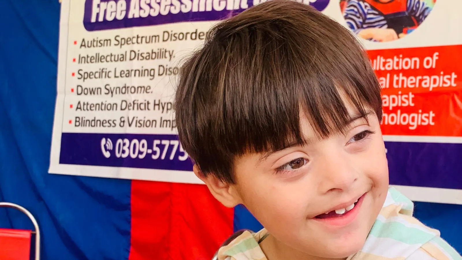 A boy smiling at the Free Birds free assessment camp